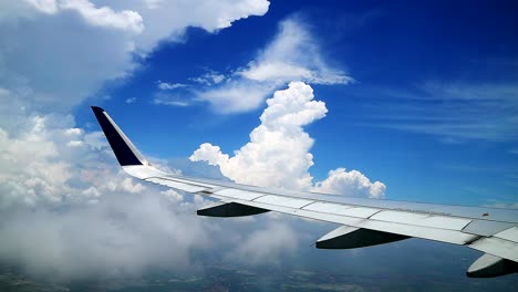 beautiful cloudy blue sky with airplane wing view from windows