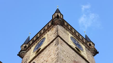 old town city hall massive prismatic clock tower with spires on blue sky day