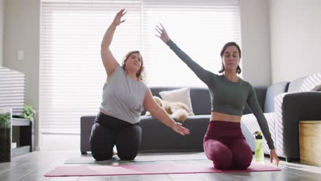 Caucasian-lesbian-couple-keeping-fit-and-stretching-on-yoga-mat