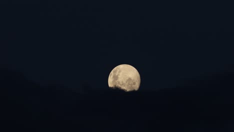 clouds passing in front of the full moon