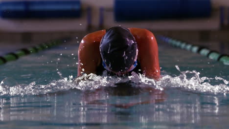 fit swimmer doing the breast stroke in swimming pool in cinemagraph