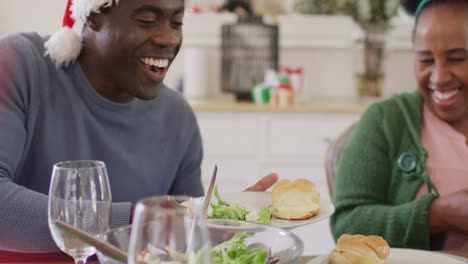happy african american family having christmas dinner