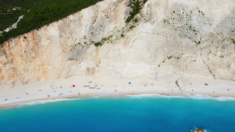 drone shot of porto katsiki beach in lefkada with turquoise sea water bordered by white mountains