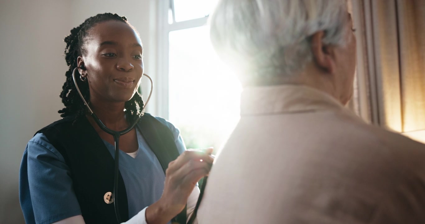 Home Healthcare Nurse Examining Senior Patient with Stethoscope