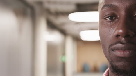 close-up of african american man in office hallway, focusing on professional expression, copy space