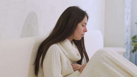 Sick-Woman-Coughing-Sitting-On-The-Bed-At-Home