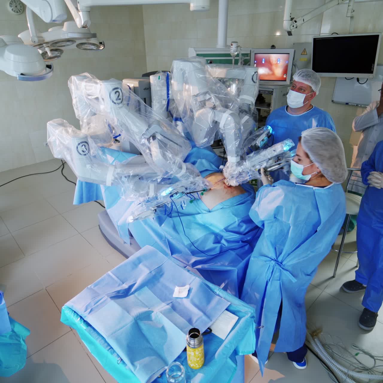 High-tech surgery with robotic equipment. Medical team performing an operation on a patient with a futuristic robot in modern operating theater.