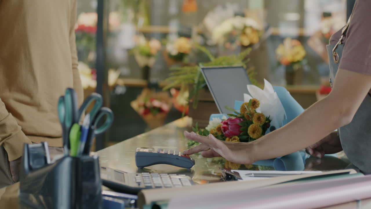 Customer Paying for Flowers at a Florist