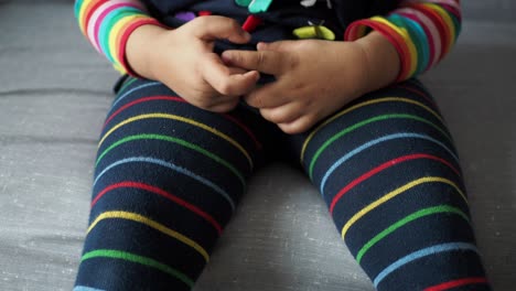 cute baby sitting in striped leggings