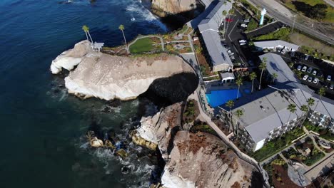 hotel by the cliff drone aerial shot - rocket up