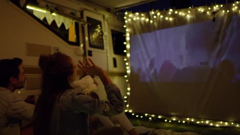 video of young cheerful people watching a movie.