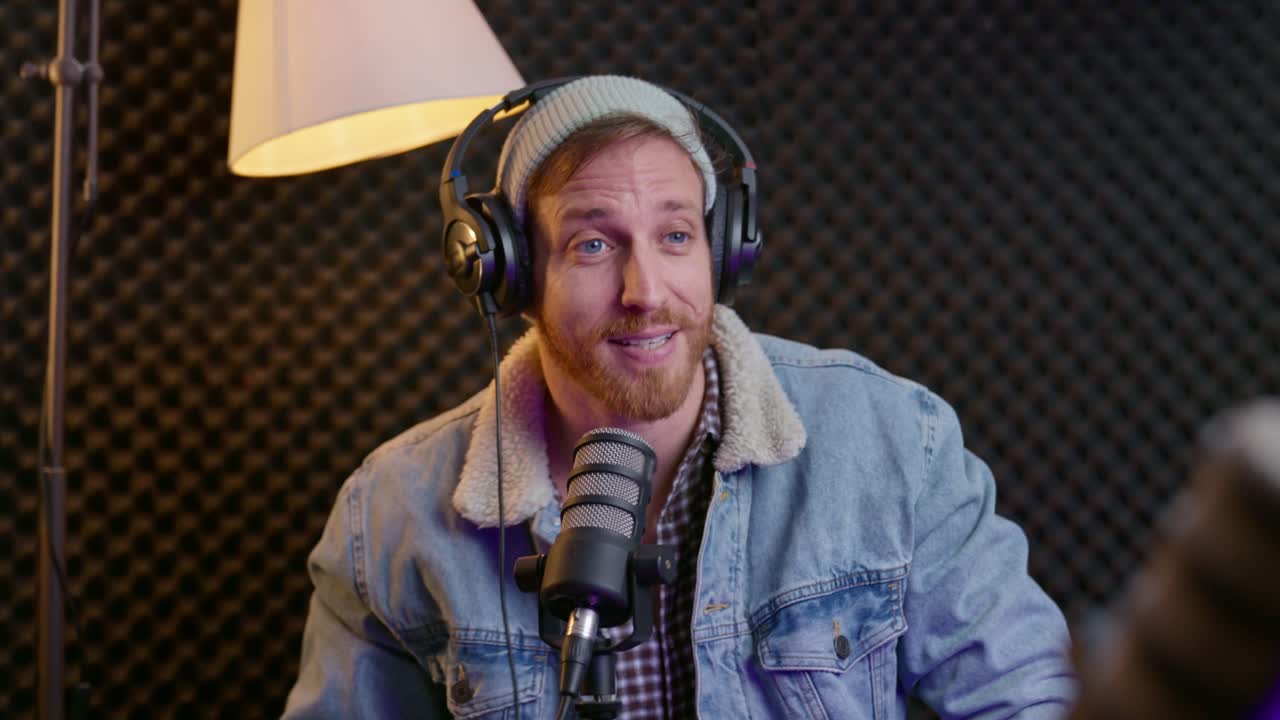 Podcaster in dynamic conversation with a guest, speaking into professional microphones in studio setting. Discussion, storytelling, media, and broadcasting. Interviews, content creation, modern media.