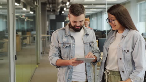 coworkers discussing project on tablet