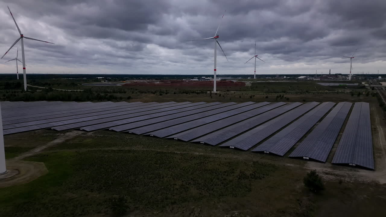 Renewable energy farm on stormy day, aerial drone view
