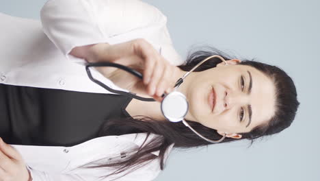 vertical video of doctor listening to camera with stethoscope.