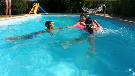 Children-playing-with-rubber-ring-in-swimming-pool-on-sunny-day.