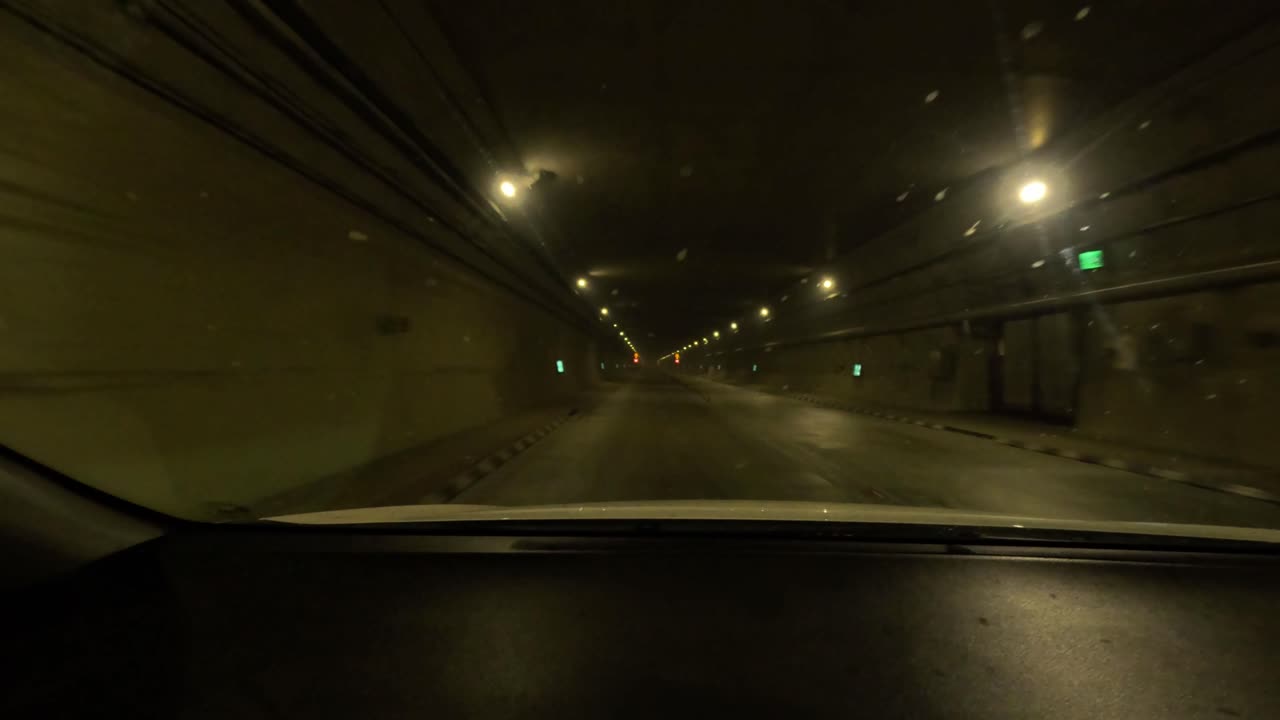 Driving through a snow-covered tunnel at night