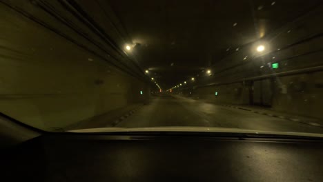driving through a snow-covered tunnel at night
