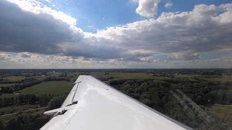 passenger view on wing of airplane landing on the runway