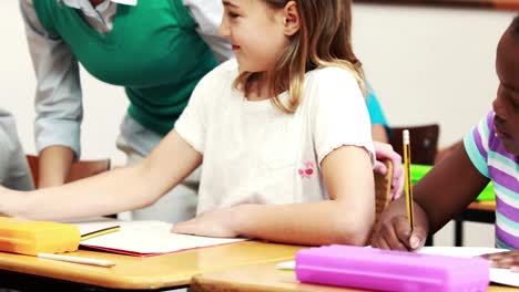 Teacher-helping-her-pupil-during-class
