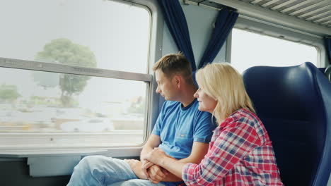 couple look out train window