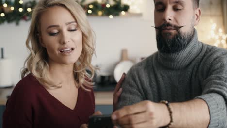 couple making photos of christmas decorations