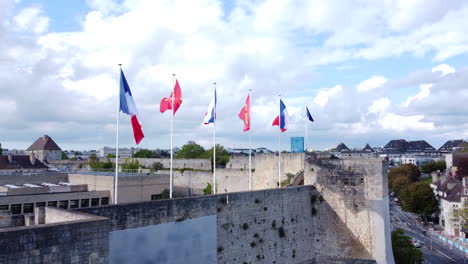 Flags-of-France,-Europe-and-Caen-on-Caen-City-Caste-Wall-AERIAL