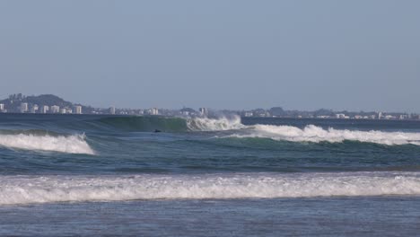 sequential view of ocean waves hitting the beach