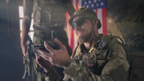 soldiers looking at a smartphone