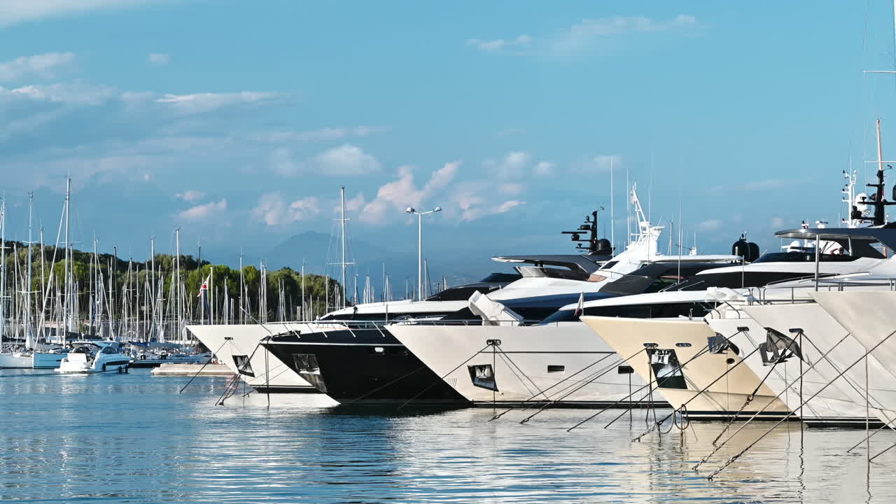 View of the sea port of Antibes, France. Moored yachts, blue water of the Mediterranean sea
