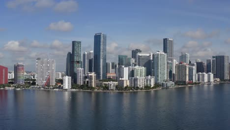 Aerial-shot-of-downtown-Miami-from-Biscayne-bay-slowly-moving-towards-the-city-from-a-low-to-higher-altitude