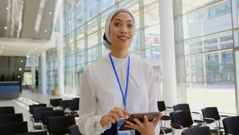 Asian-businesswoman-holding-digital-tablet-in-the-lobby-at-office-4k