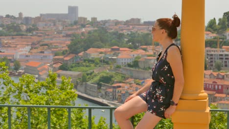 beautiful woman overlooking vila nova de gaia from porto side, portugal