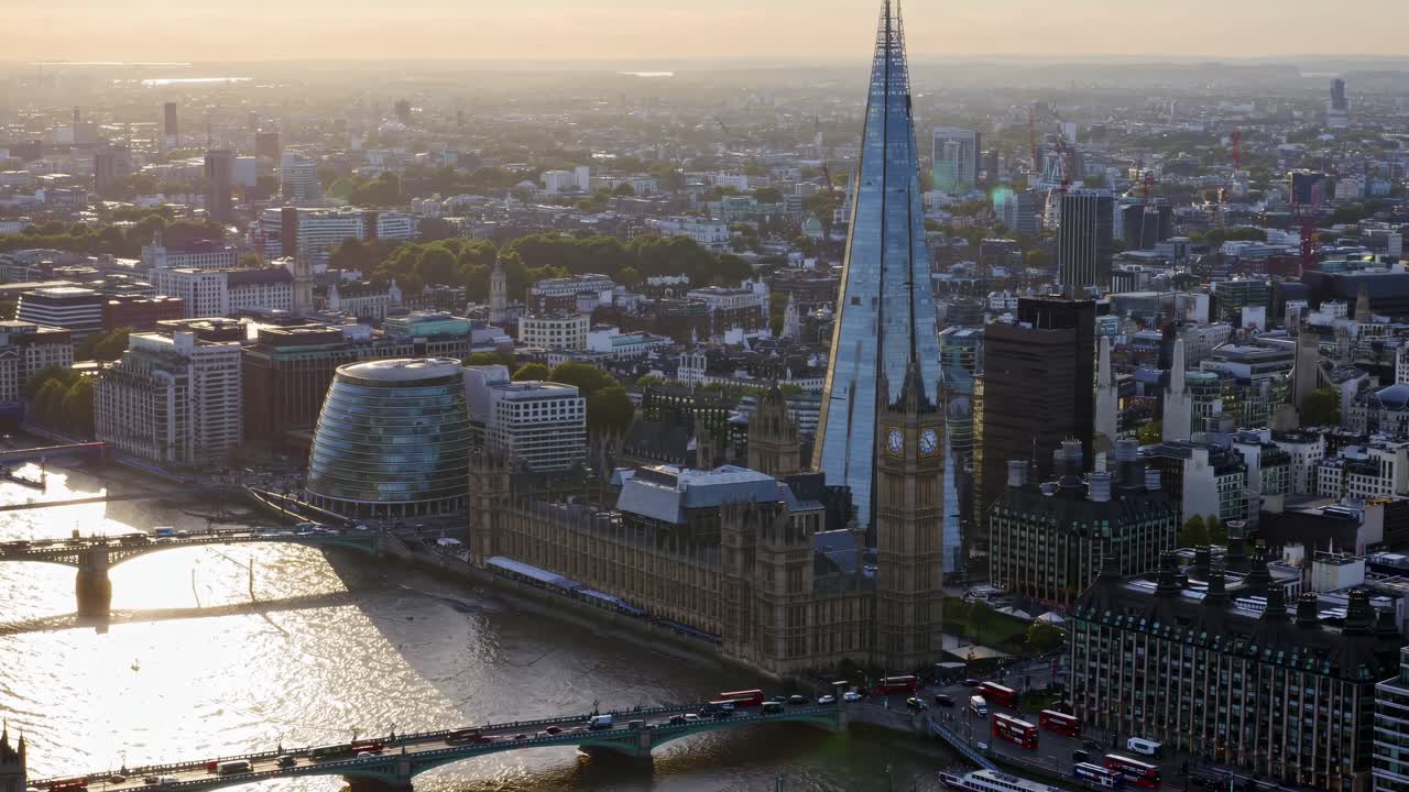 Aerial video shot of Big Ben at dusk, showcasing its illuminated clock face against a backdrop