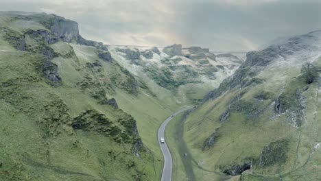 aerial view of vehicles driving through winnats pass in the winter season, peak district