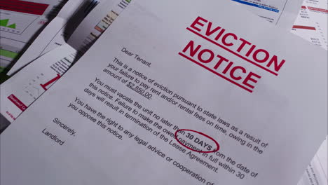 eviction notice falls down on pile of past due bills