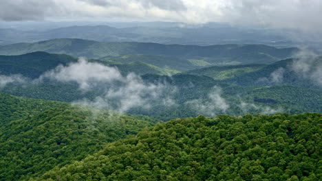 fog drapes the vast smoky terrain as a drone slowly soars overhead