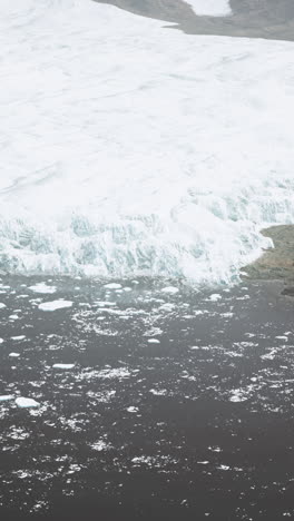 glacier melting into a black sand beach