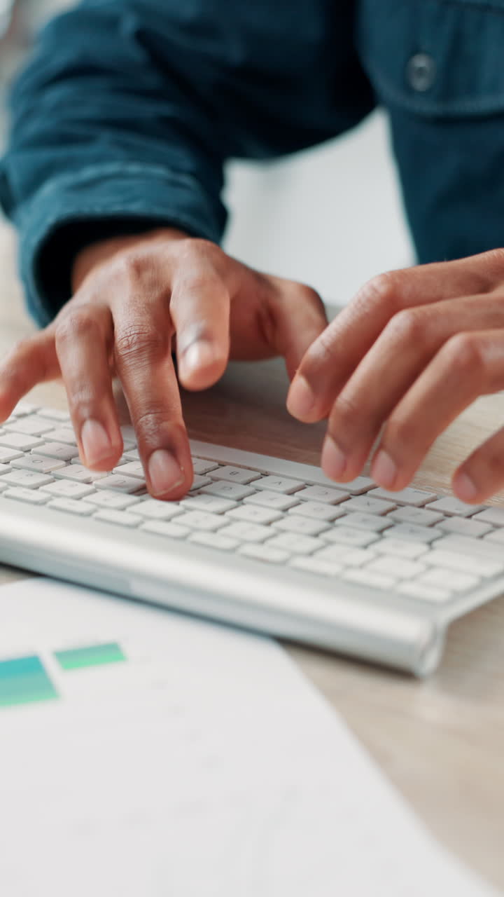 Close Up of Hands Typing on a Computer Keyboard at a Desk