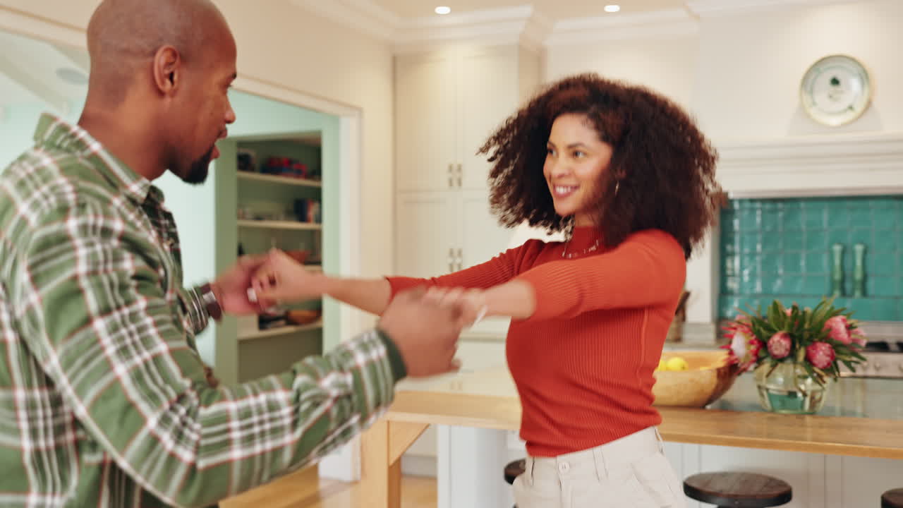 A couple dancing in their kitchen