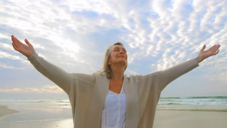 Active-senior-Caucasian-woman-standing-on-the-beach-4k