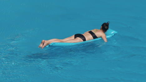 woman swimming on a blue water pool