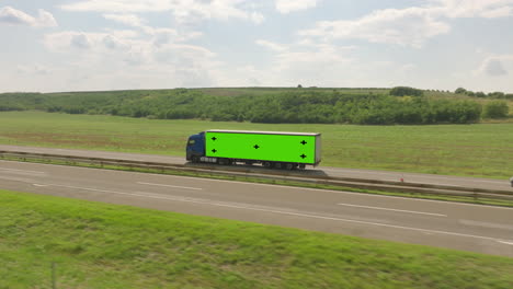 truck on highway with green screen trailer