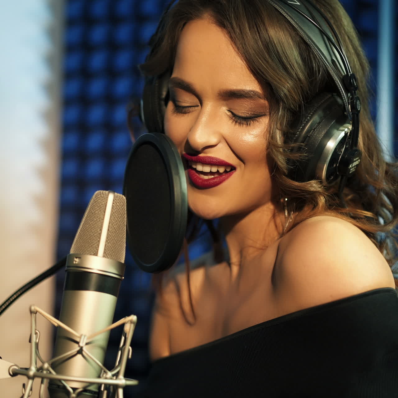 Vinnitsa, Ucraina - Maggio 2019: Primo piano di ragazza con le cuffie che canta una canzone. Studio di registrazione professionale.