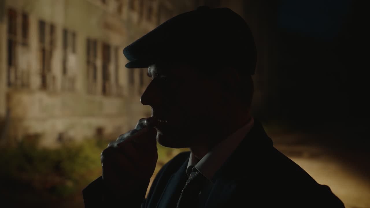 Silhouette of a man smoking at night