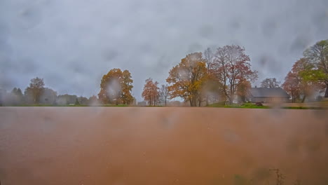 Day-to-night-long-duration-time-lapse-of-a-cottage-on-a-lake-with-multiple-weather-changes---sunrise,-day,-night,-sunset,-stormy