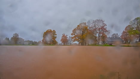 day-to-night long duration time lapse of a cottage on a lake with multiple weather changes - sunrise, day, night, sunset, stormy