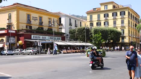 people and scooters in a bustling street