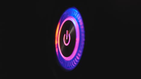 un bucle de video macro de 4k de un botón de encendido de la computadora en la unidad del sistema sobre un fondo negro.