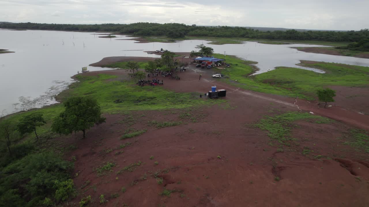 Drone view of gathering by remote river in Rio Verde, Venezuela